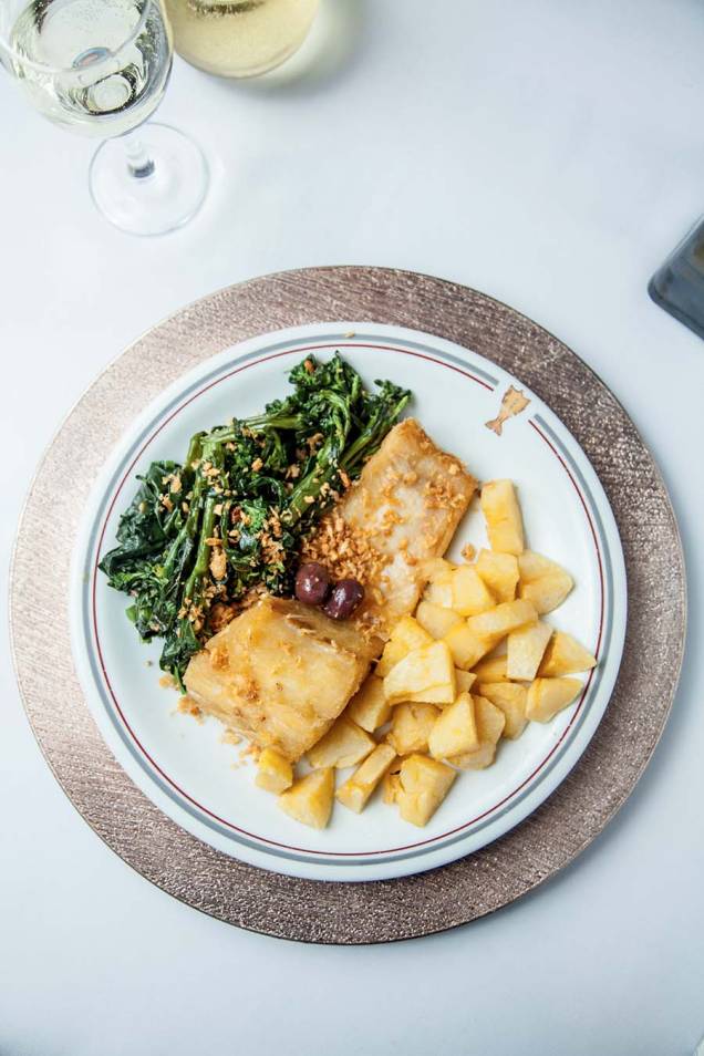 Bacalhau feito no azeite acompanhado de batata corada, azeitona e brócolis