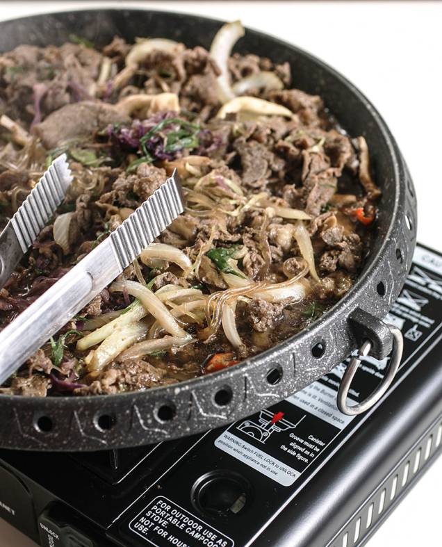 Feito na mesa em chapa metálica, o bul go gui, ou churrasco coreano, compõe-se de tiras de contrafilé ao molho agridoce Feito na mesa em chapa metálica, o bul go gui, ou churrasco coreano, compõe-se de tiras de contrafilé ao molho agridoce