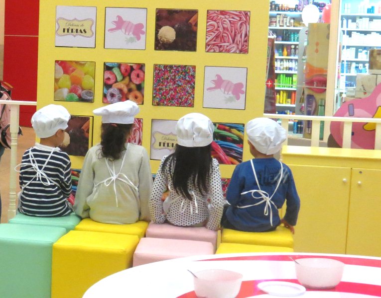 As crianças preparam e decoram biscoitinhos e brigadeiros