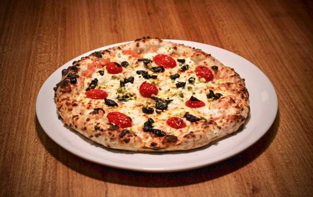Pizza de alho negro, mussarela e ricota de búfala, tomate-cereja e pistache Pizza de alho negro, mussarela e ricota de búfala, tomate-cereja e pistache