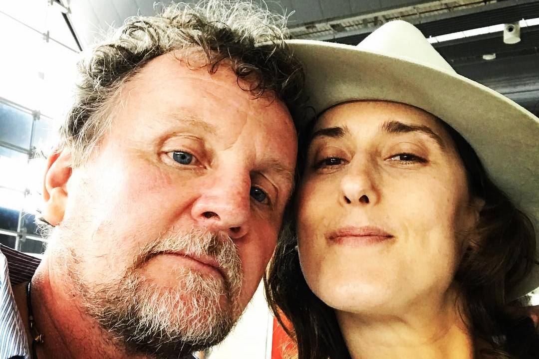 Imagem mostra selfie de Jason e Paola: ela sorri, usando chapéu, ele está sério