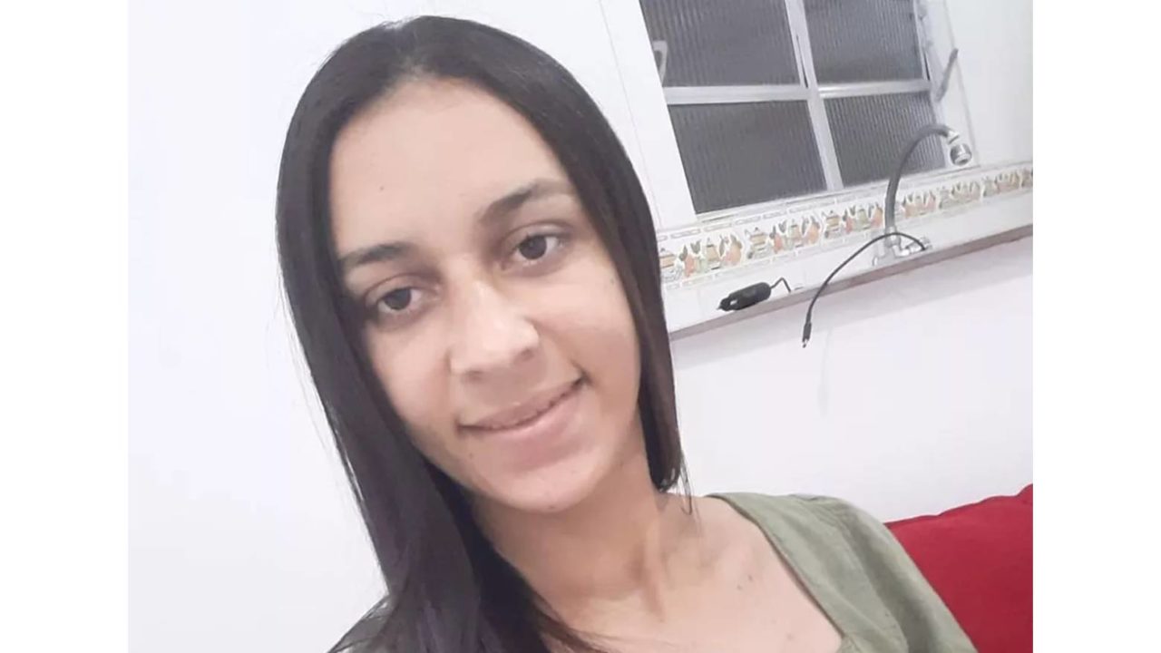 Selfie de mulher com cabelo preto longo e camiseta verde.