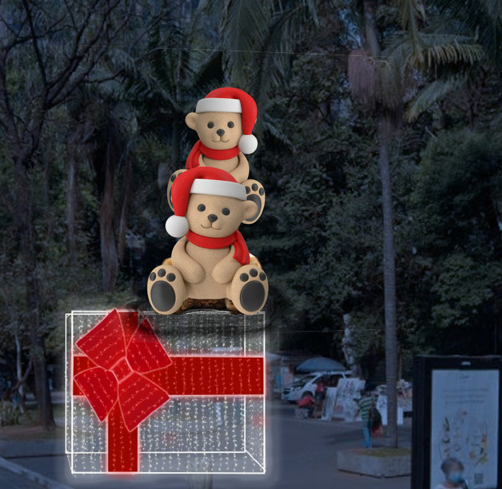 Natal na Paulista Uma projeção mostra uma caixa de presente de Natal e dois ursinhos natalinos acima dela