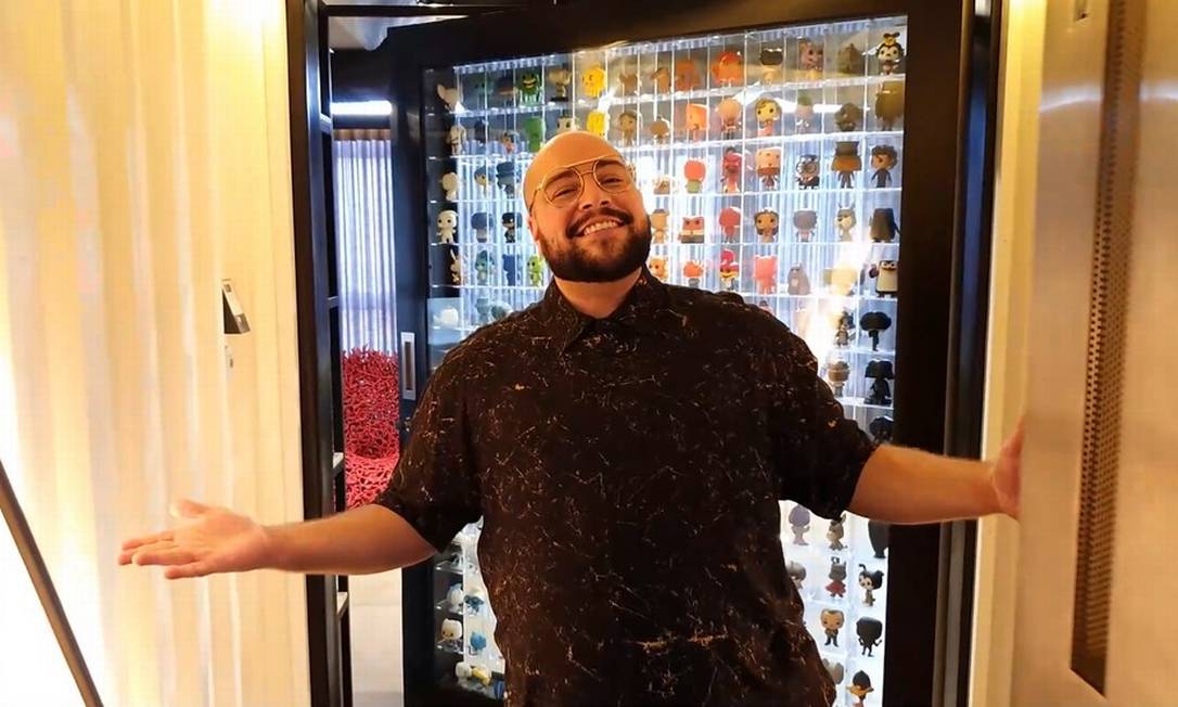 Imagem de Tiago sorrindo na porta do apartamento, decorada com bonecos