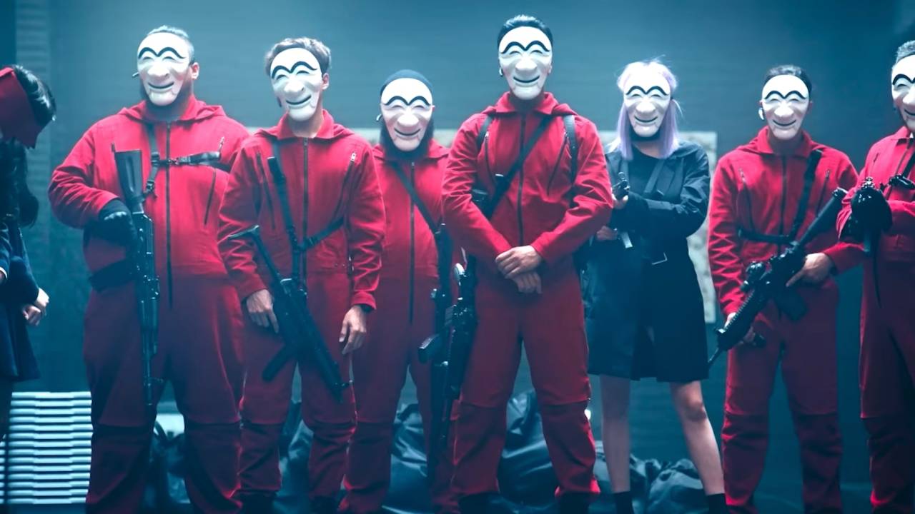 Imagem msotra fileira de pessoas vestindo coletes vermelhos e máscaras brancas