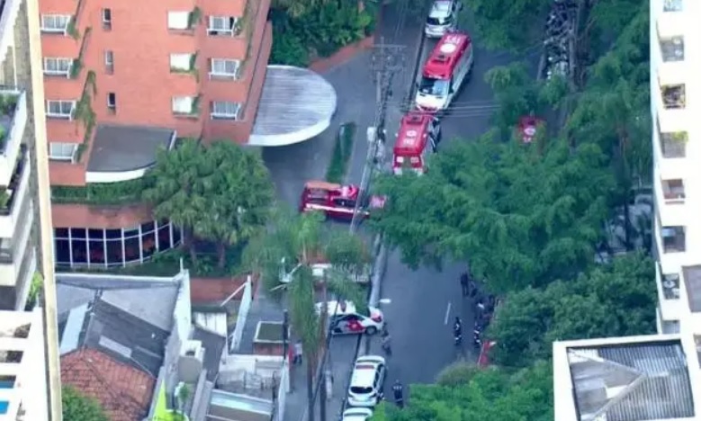 Imagem mostra viaturas da polícia em frente a prédios residenciais