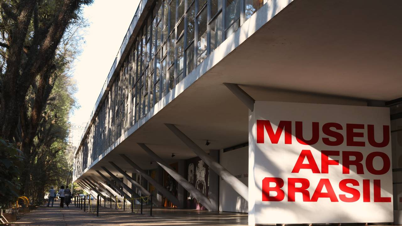 Parte externa do Museu Afro Brasil, em um dia ensolarado, com pouco movimento.