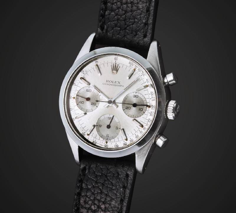 Foto de Rolex de fundo branco e pulseira de couro.