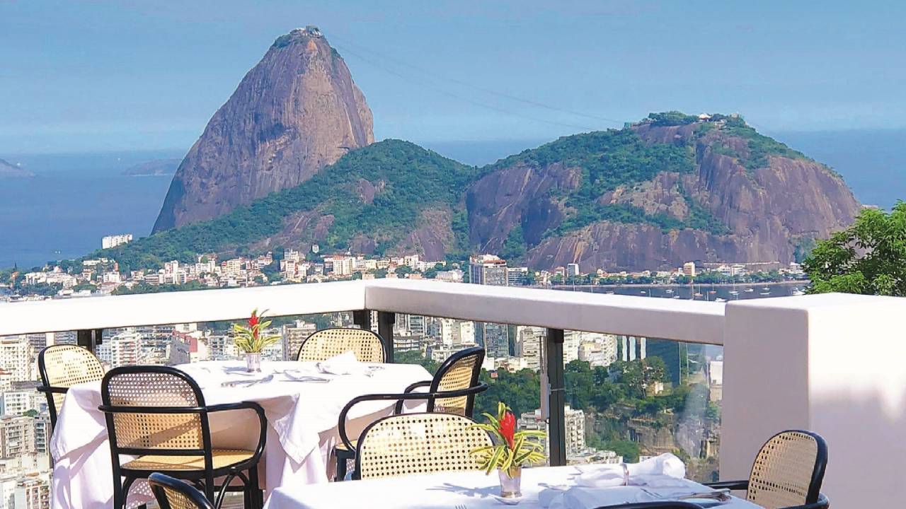 Vista do Pão de Açúcar em uma sacada com mesas e cadeiras