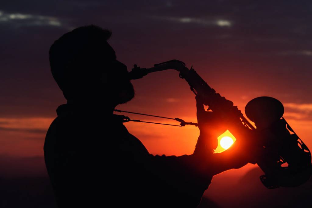 Amanhecer Parque Bondinho 2.jpg Homem tocando saxofone com sol atrás