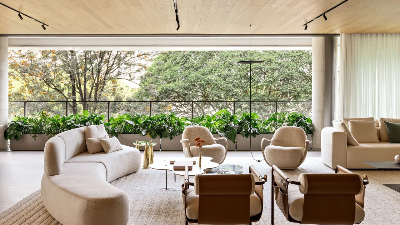 Apê repleto de luz natural tem vista privilegiada para a copa das árvores